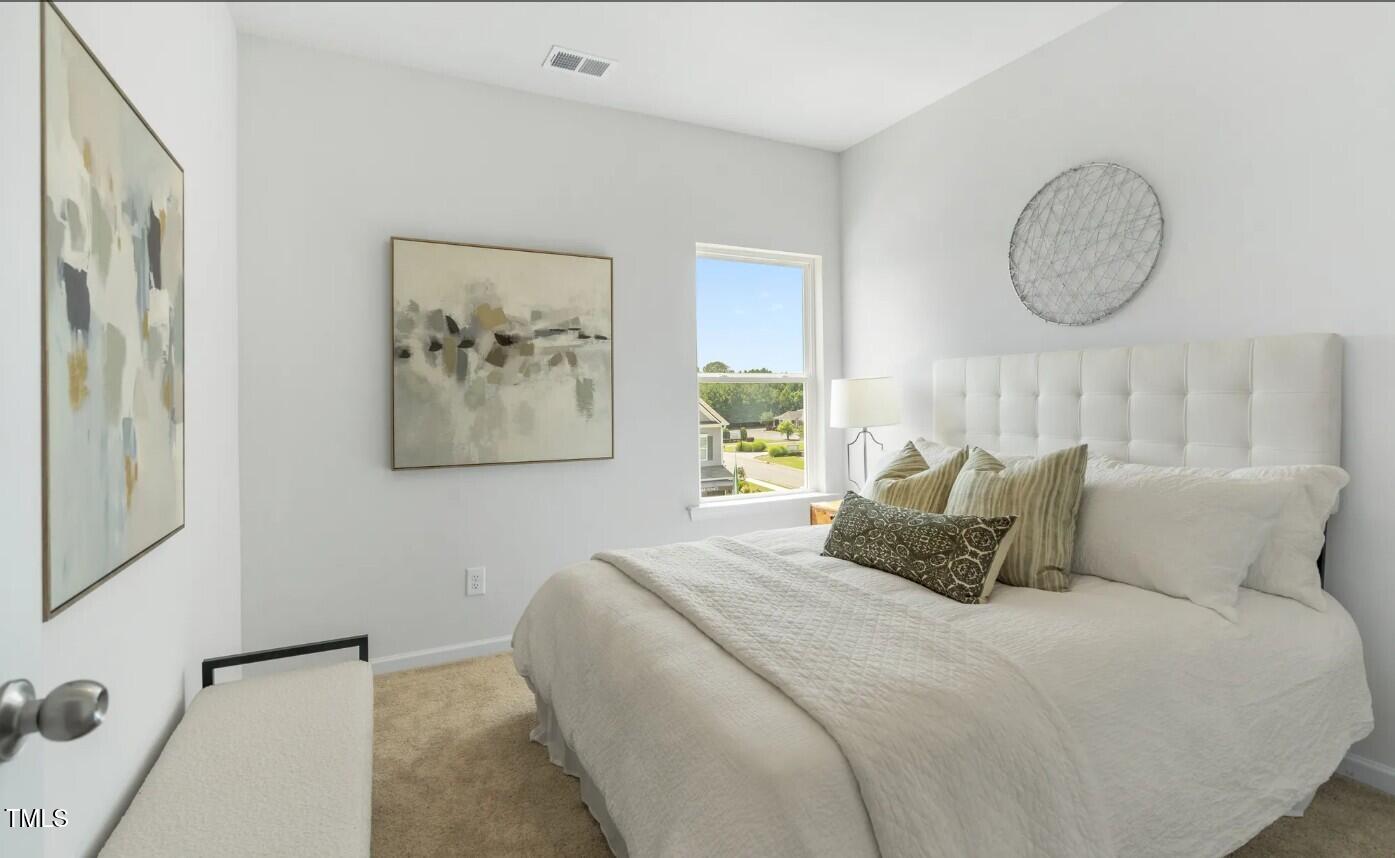 732 Orch Vista Circle Raleigh, NC 27606 - Photo 16 of 19 a bedroom with bed and a painting on the wall