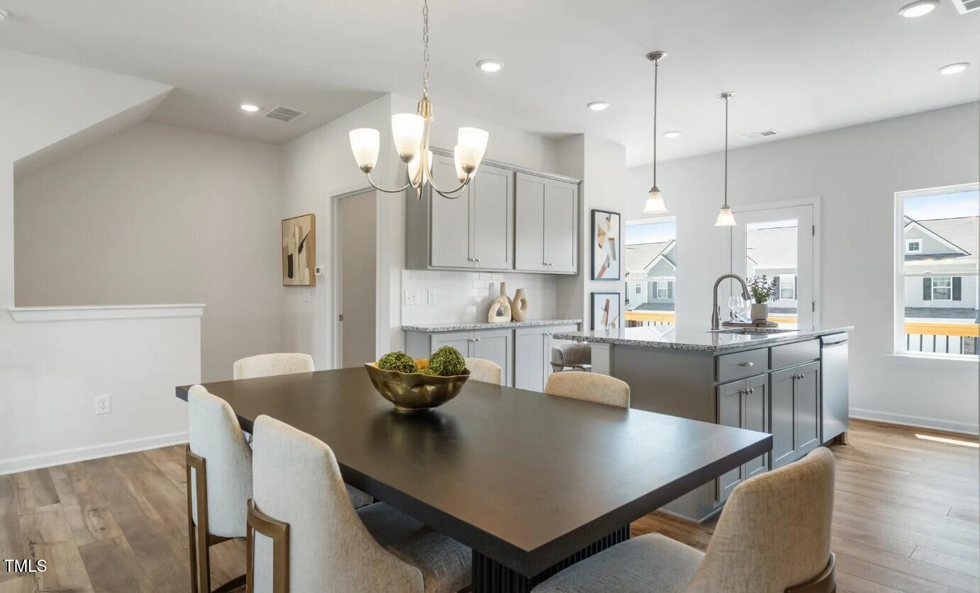 732 Orch Vista Circle Raleigh, NC 27606 - Photo 7 of 19 a large kitchen with a table and chairs