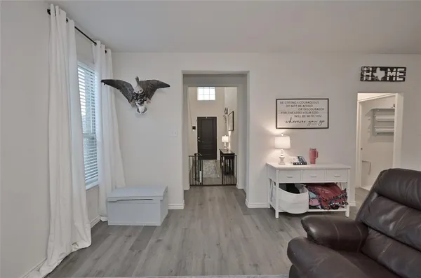 a living room with furniture and kitchen view