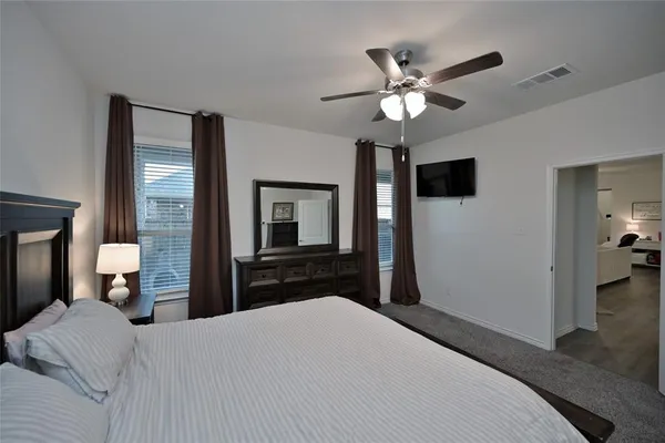 a bedroom with a bed and a chandelier