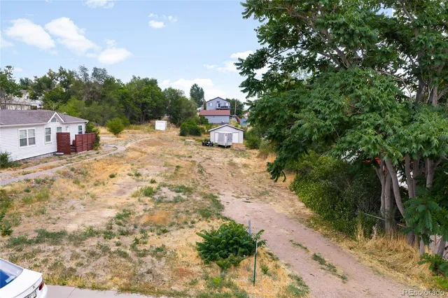 a view of a road with a house in the background