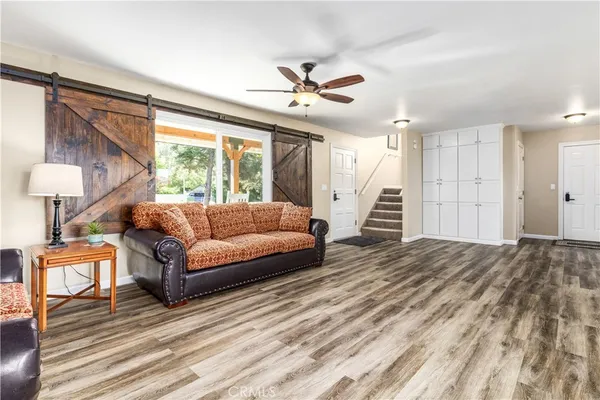 a living room with furniture and kitchen view
