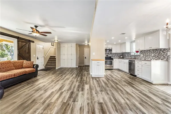 a kitchen with granite countertop a sink and a stove
