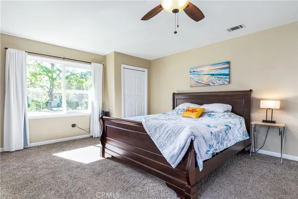 an empty room with a ceiling fan and window