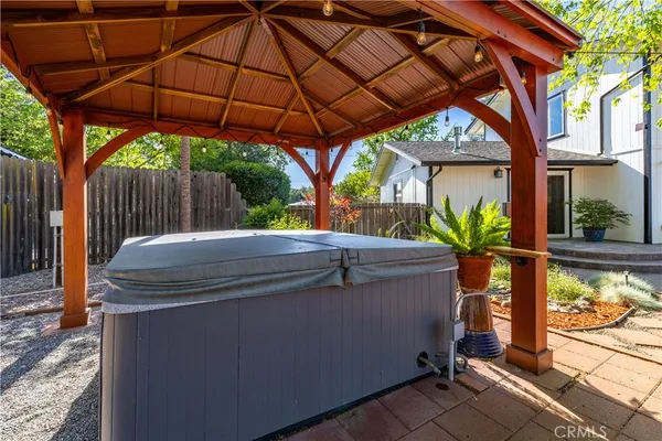 a view of a lush green field with mountains in the background
