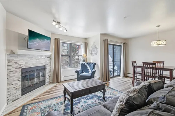 a living room with furniture a fireplace and a flat screen tv