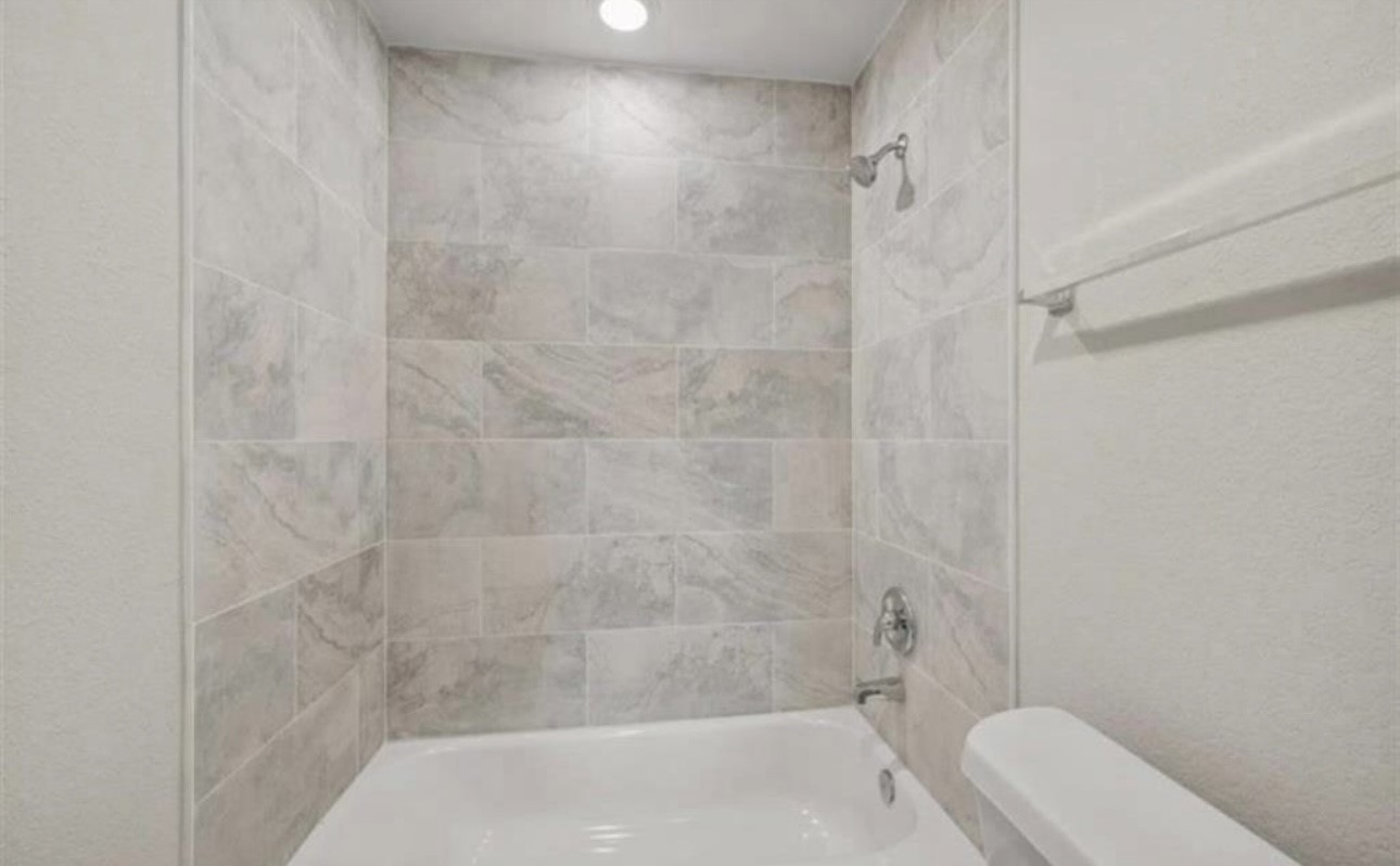 6801 Haight Street, Unit B Houston, TX 77028 - Photo 5 of 8 a bathroom with a shower and toilet