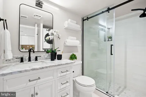 a bathroom with a shower and mirror