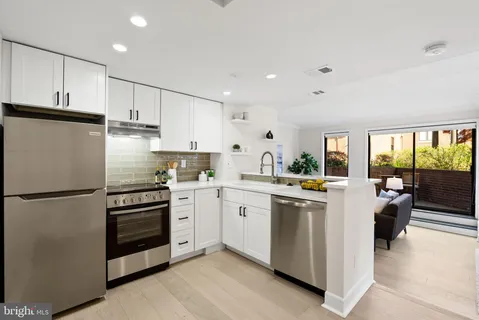 a kitchen with refrigerator and cabinets