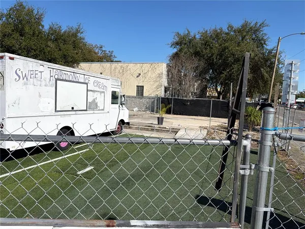 a view of a patio with table and chairs with wooden fence