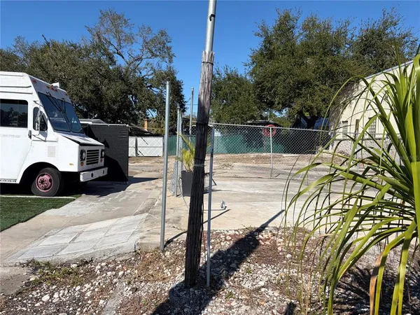 a swimming pool with outdoor seating and yard in the back
