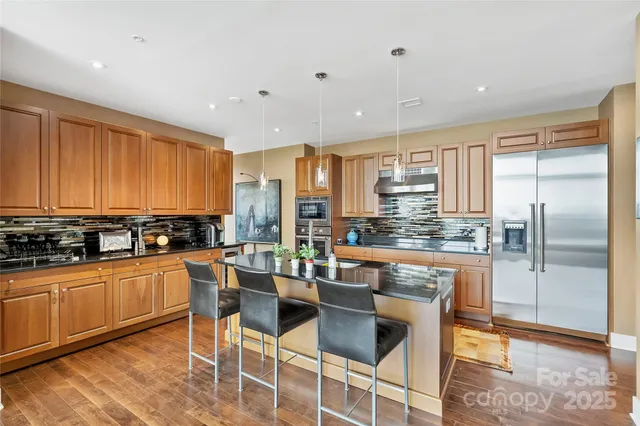 a kitchen with stainless steel appliances granite countertop counter space a sink and cabinets