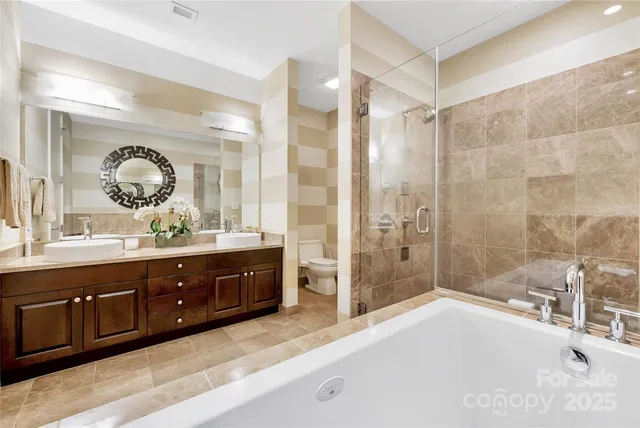a spacious bathroom with a double vanity sink mirror and shower