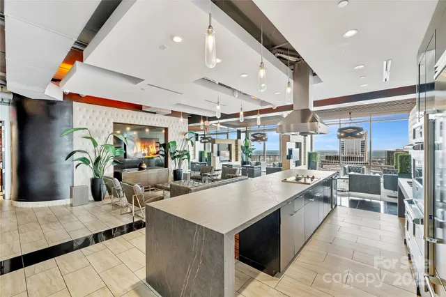 a living room with stainless steel appliances kitchen island granite countertop a table and chairs