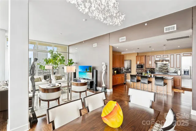 a living room with furniture and a chandelier