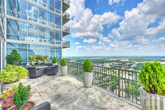 a view of a fountain in the balcony with potted plants