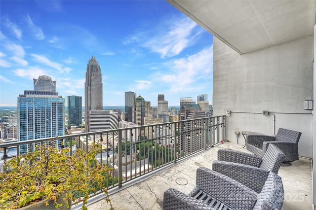 a view of a balcony with two chairs and a table