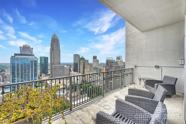 a view of a balcony with two chairs and a table