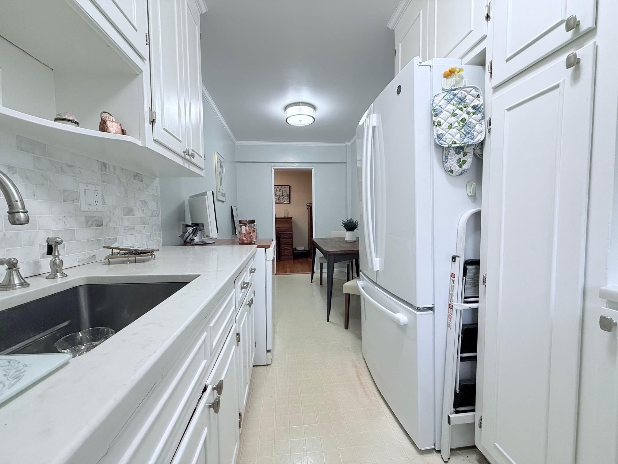 83-15 98th Street, Unit 3C Queens, NY 11421 - Photo 6 of 12 a kitchen with a sink and refrigerator