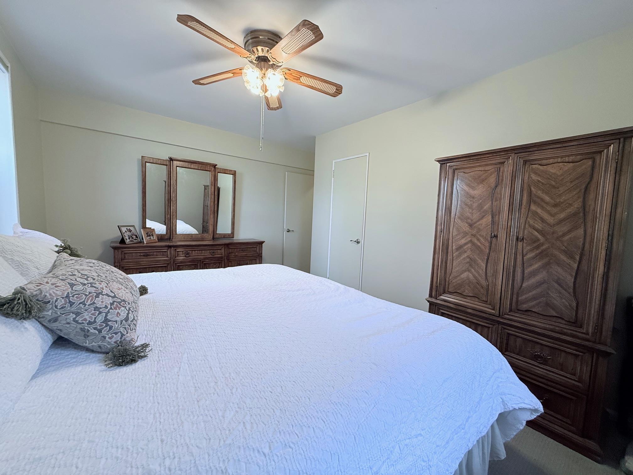 83-15 98th Street, Unit 3C Queens, NY 11421 - Photo 8 of 12 a bedroom with a large bed and a chandelier