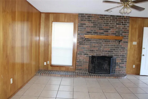 a view of an empty room with a fireplace