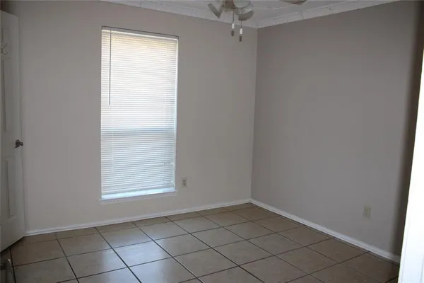 an empty room and chandelier fan