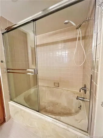 a bathroom with a glass shower door