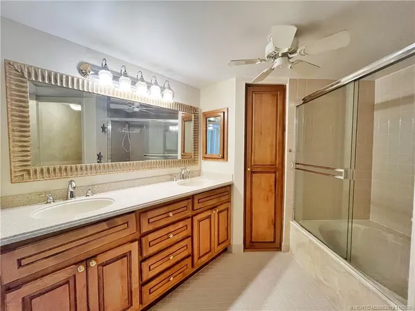a spacious bathroom with a double vanity sink mirror and double