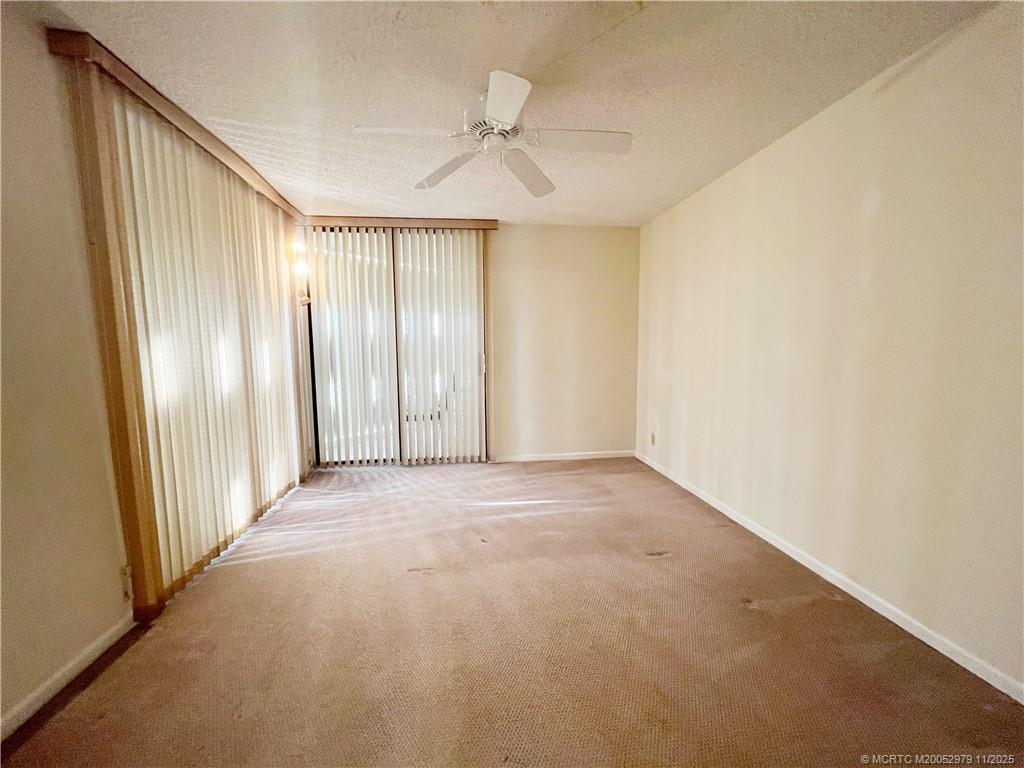 9500 South Ocean Drive, Unit 1410 Jensen Beach, FL 34957 - Photo 9 of 17 an empty room with windows and closet area