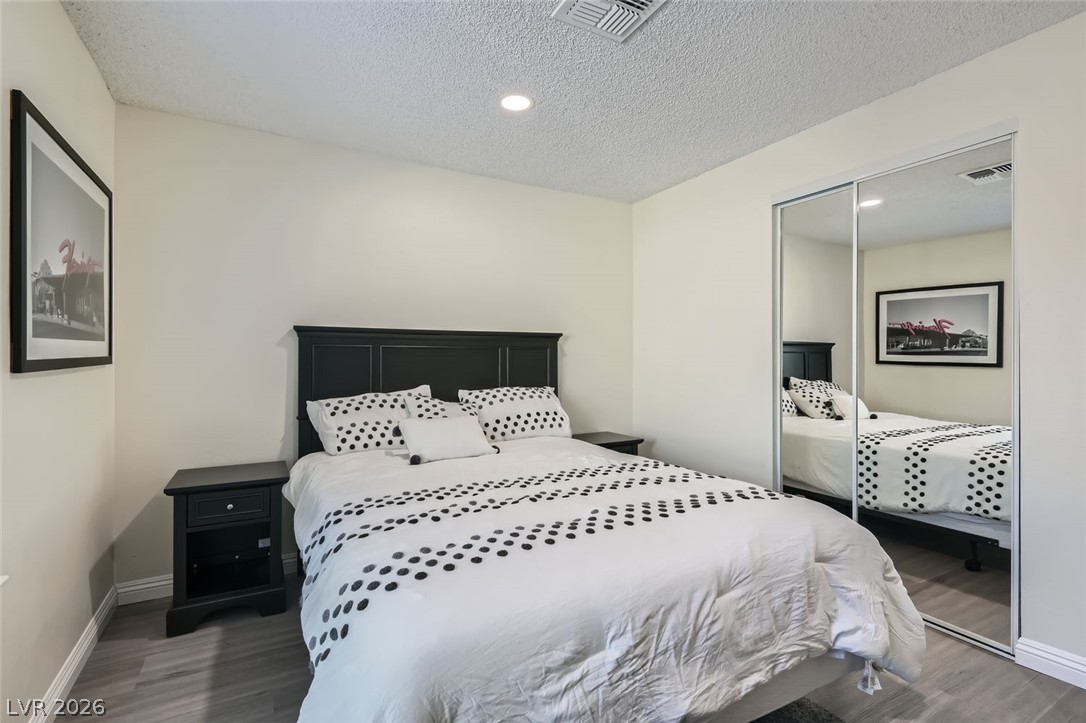 3665 Bronco Road Las Vegas, NV 89103 - Photo 18 of 28 Recessed lighting illuminates this inviting room featuring mirrored closet doors and durable flooring.
