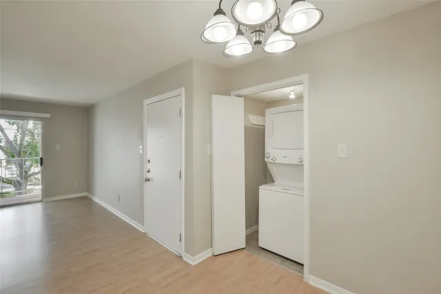 a kitchen with white cabinets and sink