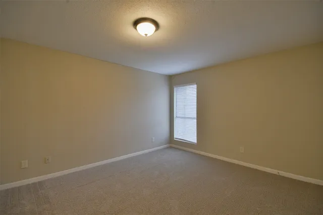 a kitchen with white cabinets and sink