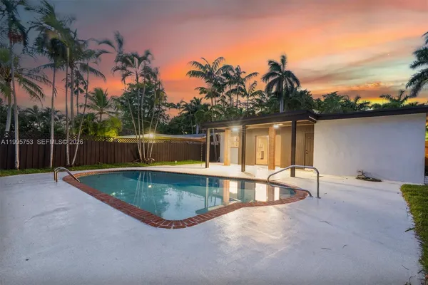swimming pool view with a garden space