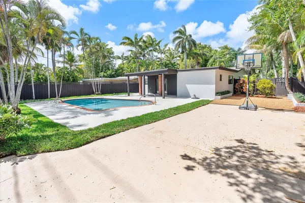 a house with a yard and a wooden fence