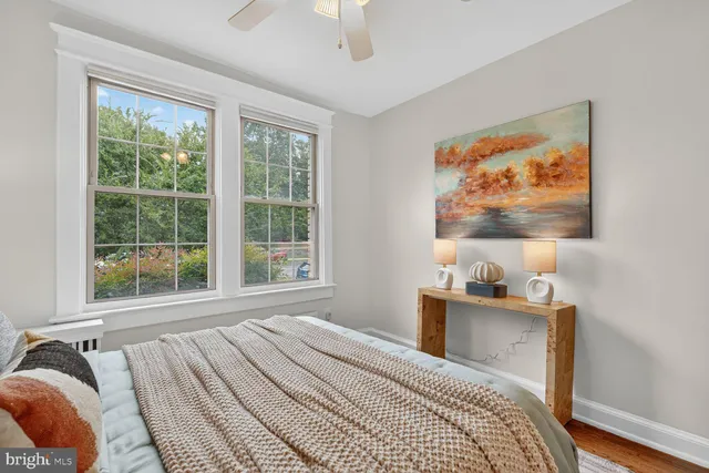 a bedroom with a bed and a painting on the wall