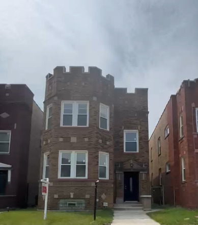 7936 South Champlain Avenue, Unit 1 Chicago, IL 60619 - Photo 1 of 8 a front view of a building with garden