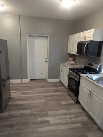 a kitchen with stainless steel appliances granite countertop a stove and a sink