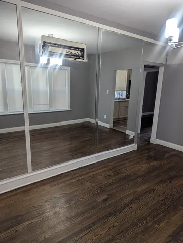 a view of a room with wooden floor