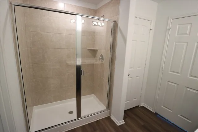 a bathroom with a glass shower door