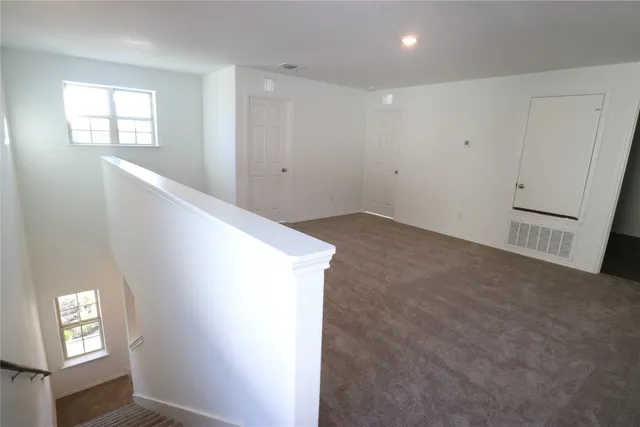 a view of an empty room with windows