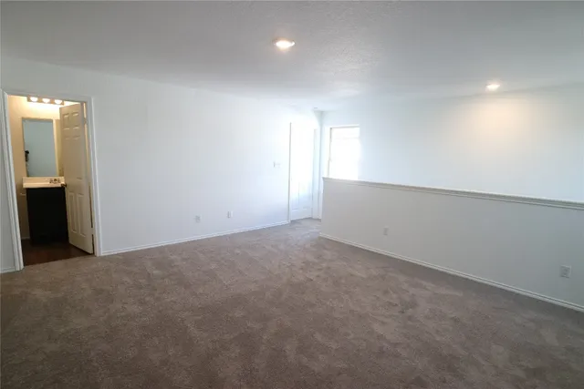 a view of an empty room and a window