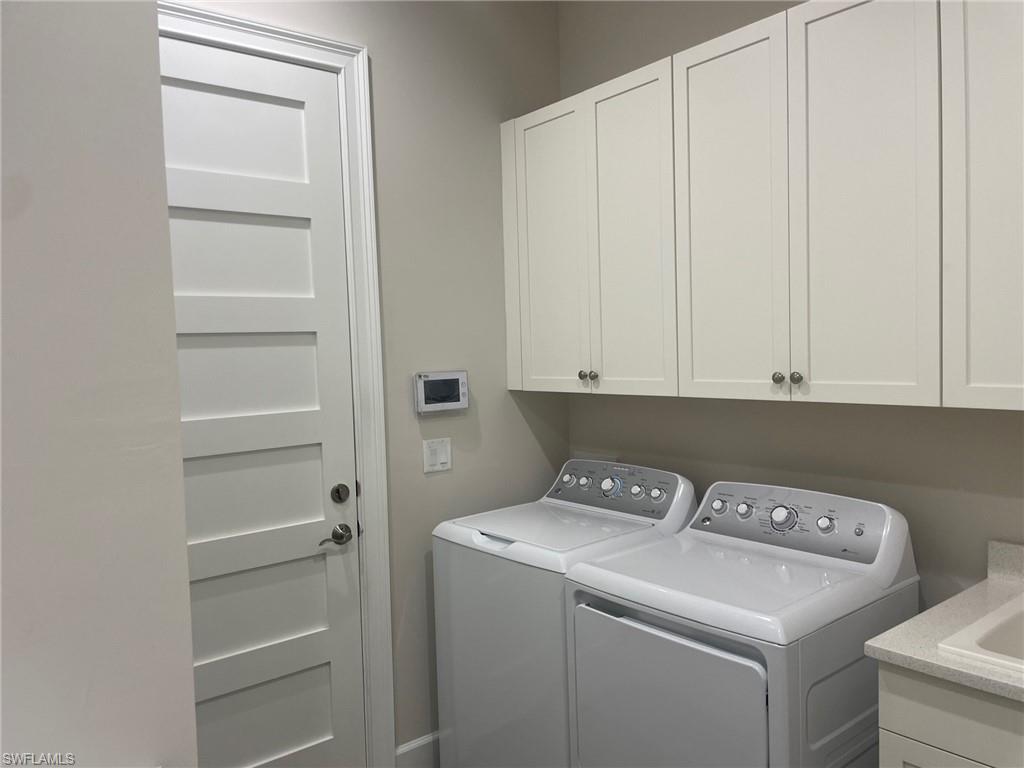 5685 Highbourne Drive Naples, FL 34113 - Photo 15 of 26 a view of storage and utility room with washer and dryer