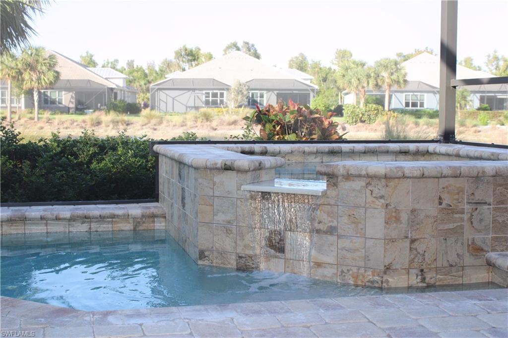 5685 Highbourne Drive Naples, FL 34113 - Photo 4 of 26 a front view of a house with a yard