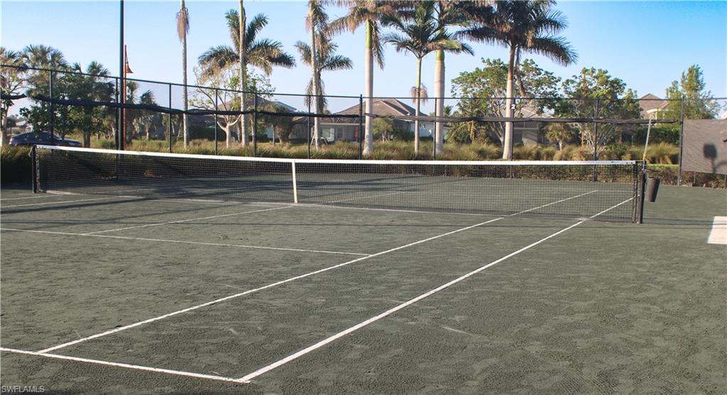 5685 Highbourne Drive Naples, FL 34113 - Photo 6 of 26 a view of a tennis court with palm trees