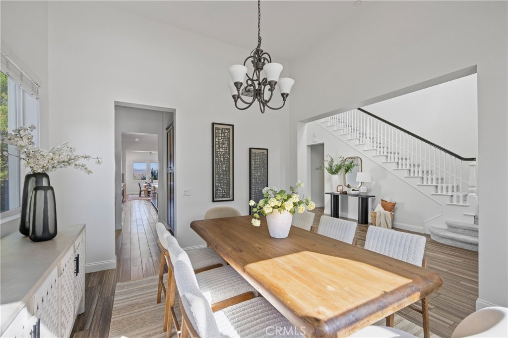 24910 Old Stone Way Stevenson Ranch, CA 91381 - Photo 11 of 67 a view of a dining room with furniture and wooden floor