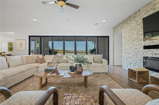 a living room with furniture ceiling fan and a rug