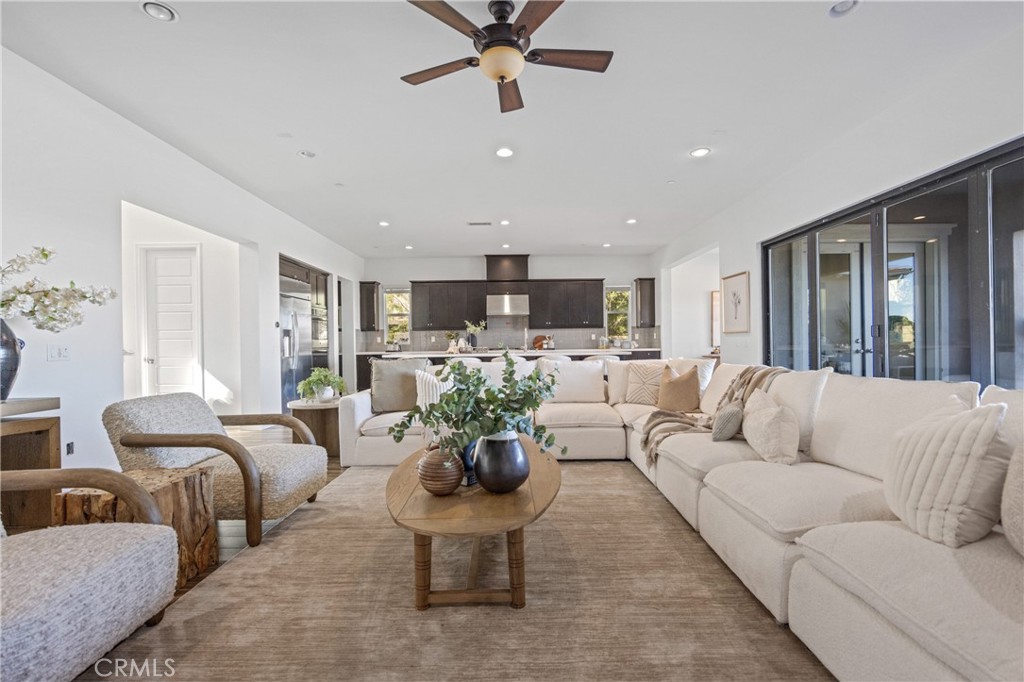 24910 Old Stone Way Stevenson Ranch, CA 91381 - Photo 18 of 67 a living room with furniture ceiling fan and a rug