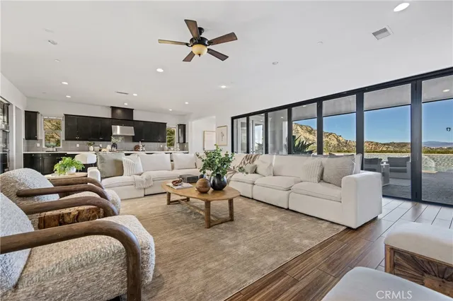 a kitchen with granite countertop a dining table chairs cabinets and stainless steel appliances