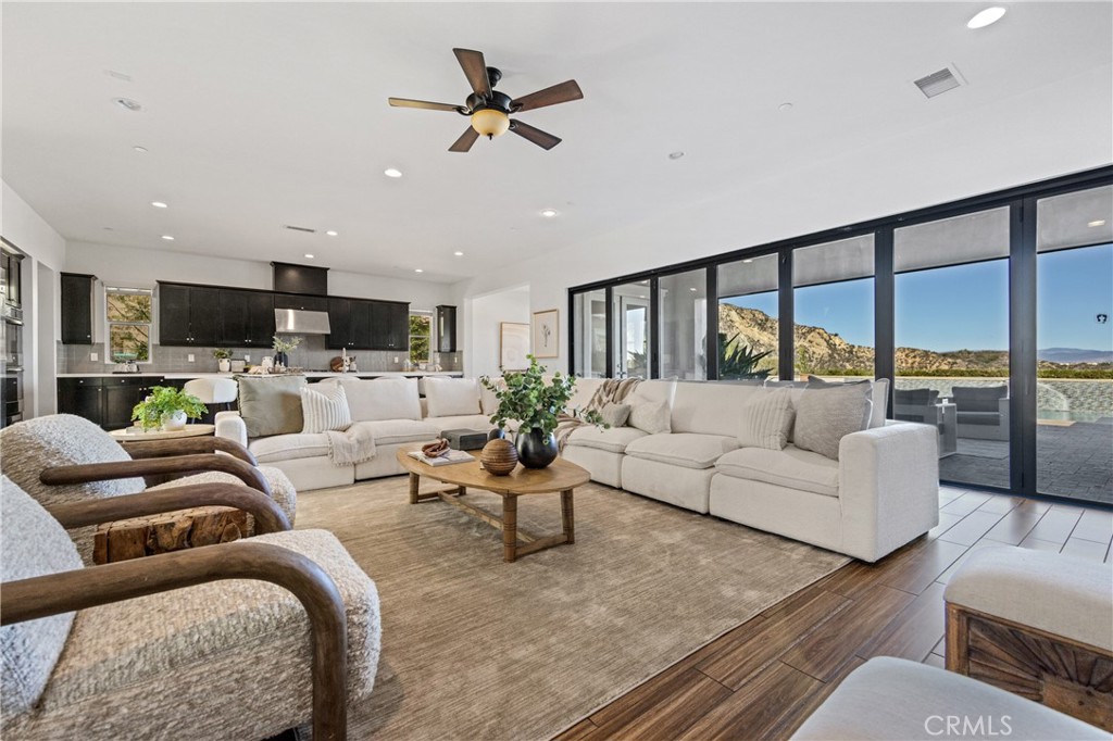 24910 Old Stone Way Stevenson Ranch, CA 91381 - Photo 19 of 67 a living room with furniture kitchen view and a large window