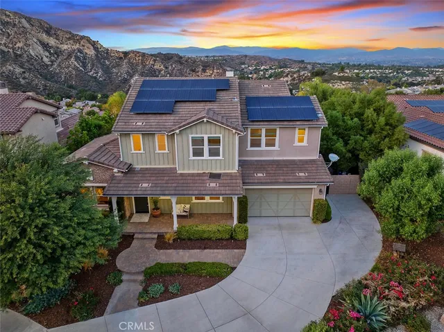 a front view of a house with a yard and a fireplace